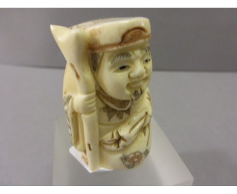 Signed Oxbone Netsuke of a Man with Sack and Stake