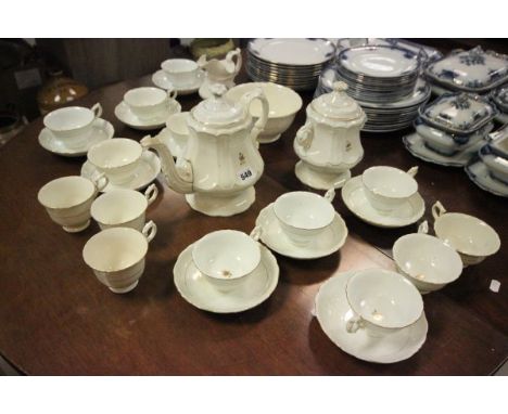 Early 19th century Rockigham Style Tea Service, Cream Ground with Gilt Borders comprising Tea Pot, Two Sugar Bowls, Jug, Elev