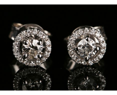 A pair of 18ct white gold and diamond cluster earrings, each circular cut diamond within an open surround set with circular c