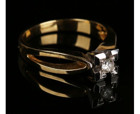 A gold and diamond single stone ring, mounted with a circular cut diamond within a square shaped setting between pierced open