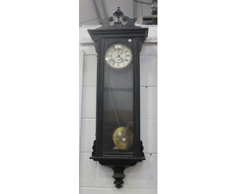 A late 19th Century ebonized case Vienna style regulator wall timepiece, the two piece enamel dial with Roman numerals and su