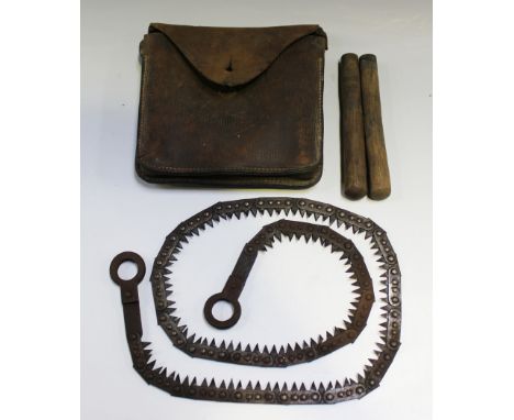 An early 20th Century hand chainsaw within a brown leather case.