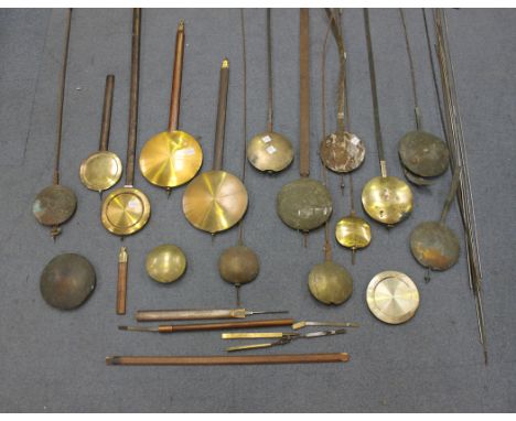 A collection of 19th and 20th Century longcase and wall clock pendulums, approximately twenty-four in total.