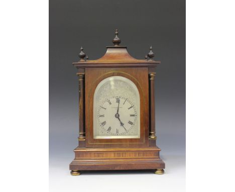 A George V mahogany mantel clock with eight day movement striking on a gong, the back plate numbered '9471', the scroll engra