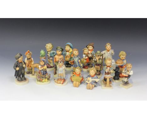 A collection of sixteen Goebel Hummel figures, including 'Confidentially', No. 314, 'Feeding Time', No. 199, 'Congratulations