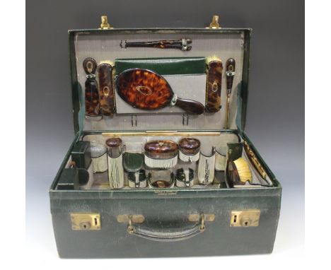 A George V green leather vanity case, partially fitted with piqué inlaid tortoiseshell accessories, including hand mirror, pa