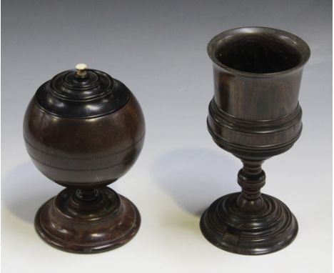 An 18th Century coconut jar and cover, the cover with a turned ivory finial, raised on a turned circular walnut foot, height 