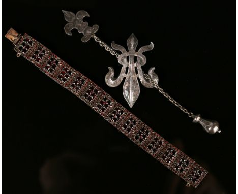 A gilt metal and Bohemian garnet set rectangular panel link bracelet, each link mounted with six garnets within a surround of
