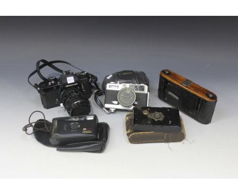 A Nikon Nikkormat camera, No FT2 5344071, with P.C Nikkor 1:2.8 f=35mm lens and a small collection of assorted cameras and ac