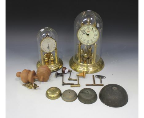 Two brass anniversary clocks with glass domes, three longcase clock winders, another brass winder, four clock bells and two t