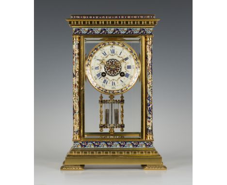 An early 20th Century French lacquered brass and champlevé enamel four glass mantel clock with eight day movement striking on