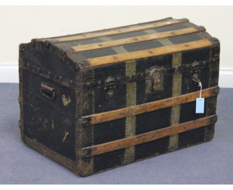 A late Victorian black canvas and wooden slatted travelling trunk, fitted with a domed hinged lid, height approx 54cm, width 