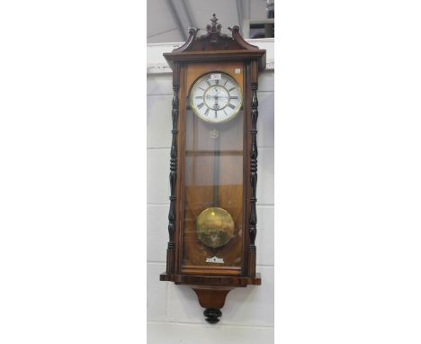A late 19th Century walnut and ebonized Vienna style wall timepiece, the two piece enamel dial with Roman numerals and subsid