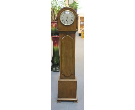 A George V mahogany diminutive longcase clock with eight day movement chiming on gongs, the silvered circular dial with Roman