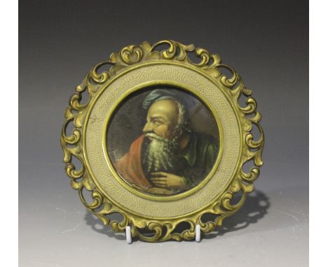 A 19th Century papier-mâché circular panel, possibly Stobwasser, painted with a head and shoulders portrait of a bearded gent