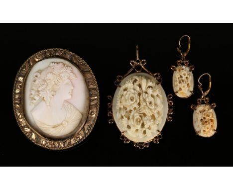 A Victorian gilt metal mounted oval carved pink shell cameo brooch, designed as the portrait of a lady, width approx 5cm, a 9