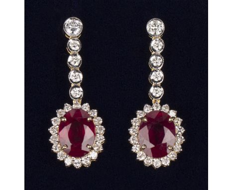 A pair of 18ct gold, ruby and diamond oval cluster pendant earrings, each with an oval cut ruby within a surround of circular