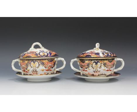 A pair of Derby Japan pattern écuelles, covers and stands, early 19th Century, each with a pair of naturalistic handles and f
