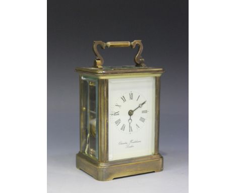 A 20th Century English brass carriage clock with eight day movement striking on a bell, the white enamel dial with Roman nume