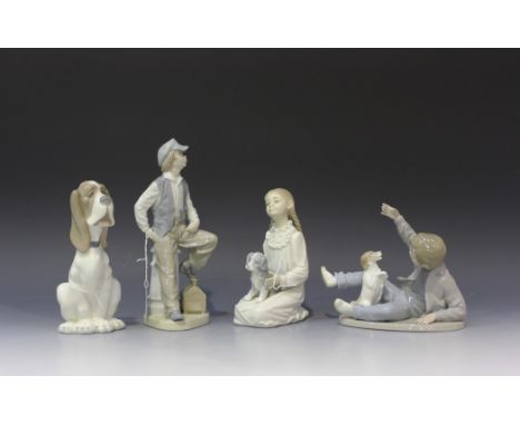 A group of four Nao porcelain figures, comprising Dog, No 375, Shoeshine Boy, No 184, Holding her Puppy, No 171, and Boy and 