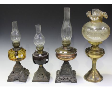 An early 20th Century brass table oil lamp with glass chimney and etched glass shade, height approx 54cm, together with three