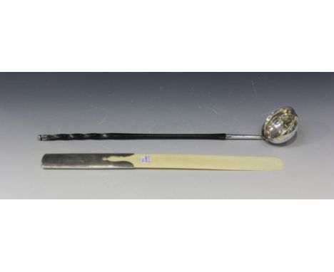 A George III silver toddy ladle, the circular bowl with a George III gilt shilling 1787, fitted with a twisted whalebone hand