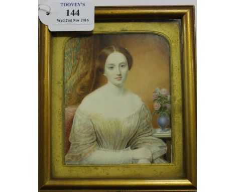 Late 19th Century British School - Half Length Miniature Portrait of a Lady seated beside a Vase of Flowers, watercolour on i