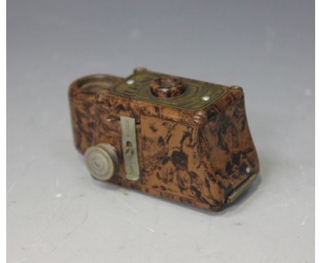 A Coronet Midget 16mm camera within a brown and black mottled Bakelite case, length approx 6.5cm.
