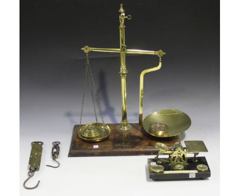 A set of late Victorian brass postal scales, a set of Victorian Avery brass balance scales and two brass spring scales.