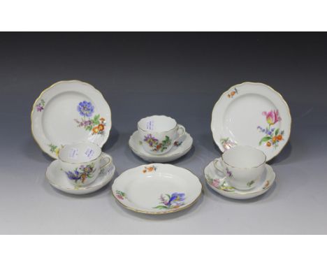 A set of three Meissen porcelain coffee cups, saucers and side plates, 20th Century, each outside painted with flowers, cance