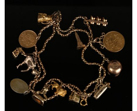 A gold four row oval chain link bracelet, fitted with a variety of pendants and charms, including a sovereign 1915, a half-so