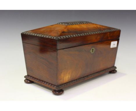 A Regency rosewood tea caddy of sarcophagus form, the hinged lid and base with bead and reel borders, on disc feet, width app