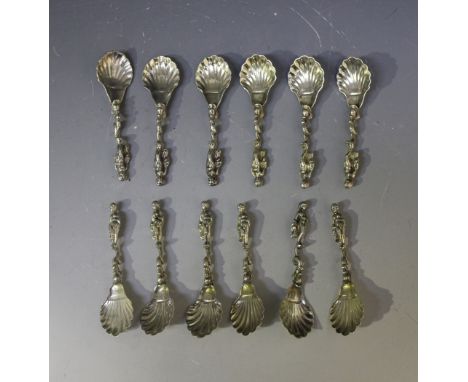 A set of twelve Continental silver salt spoons, each with scalloped bowl, dolphin stem and putto finial, indistinct mark, len