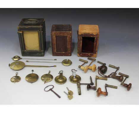 A collection of eight 19th Century and later longcase clock winding keys, six brass clock pendulums and three carriage clock 