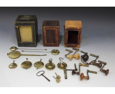 A collection of eight 19th Century and later longcase clock winding keys, six brass clock pendulums and three carriage clock 