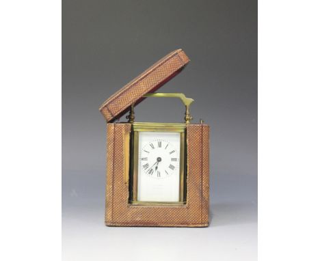 An early 20th Century brass carriage timepiece with eight day movement, the white enamel dial with Roman numerals and inscrib
