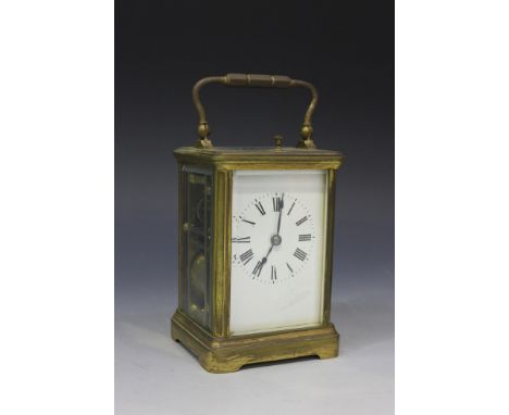 An early 20th Century French brass carriage clock with eight day movement repeating on a gong, the enamel dial with Roman num