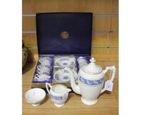 A Coalport 'Revelry' pattern part coffee service, decorated with bands of putti against a blue ground, comprising coffee pot 