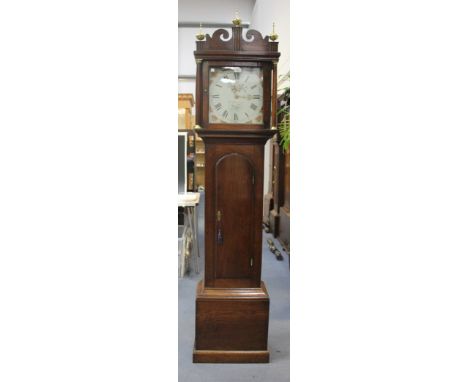 A George III oak longcase clock with thirty hour movement striking on a bell, the square painted dial with Roman numerals and