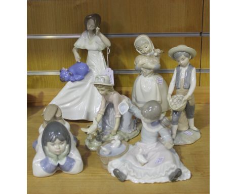 A group of six Nao porcelain figures, comprising Girl with Lambs, No 120, Shower Time, No 186, Boy with Potatoes, Caressing t