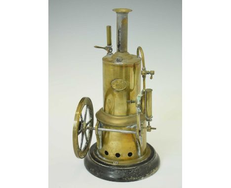 Early 20th Century German Ernst Plank live-steam vertical engine, raised on turned ebonised wooden base, 27cm high overall