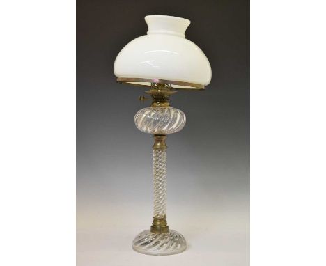 Early 20th century oil lamp, the spiral reeded clear glass stem raised on conforming dome foot with plated mounts, and opaque