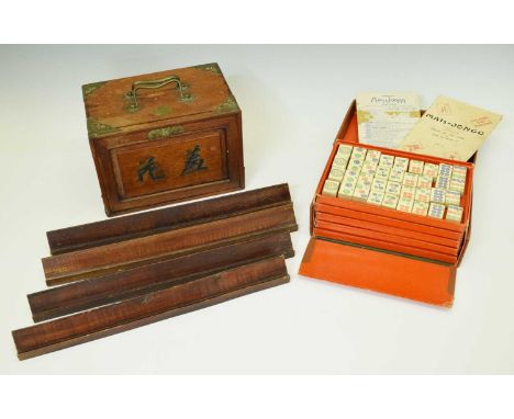 Two cased Mahjong sets, the first in brass-mounted hardwood case, the sliding front panel enclosing five drawers, 23cm wide, 