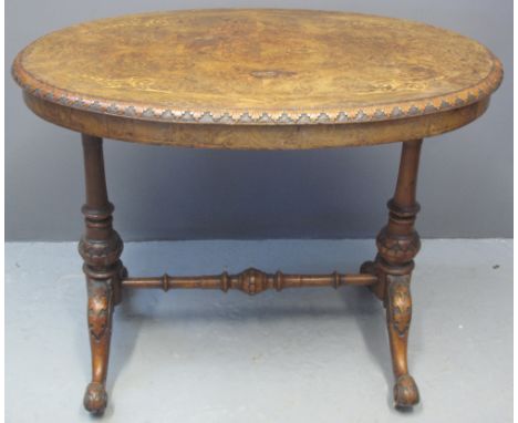 VICTORIAN WALNUT STRETCHER TABLE, of small oval form, foliate inlay to the top with carved foliage, standing on turned suppor