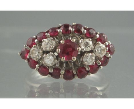 AN 18CT WHITE GOLD RUBY AND DIAMOND MARQUISE SHAPED CLUSTER RING. Set with a ruby to the centre with three brilliant cut diam