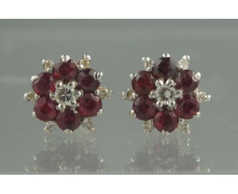 A PAIR OF 18CT WHITE GOLD DIAMOND AND RUBY CLUSTER EARRINGS. Diameter approx 10mm. Weight 3.5g approx. (B.P. 24% incl. VAT) C