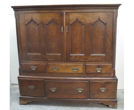 19TH CENTURY WELSH OAK LOW PRESS CUPBOARD having moulded cornice above two blind panelled and ogee fielded doors, the interio