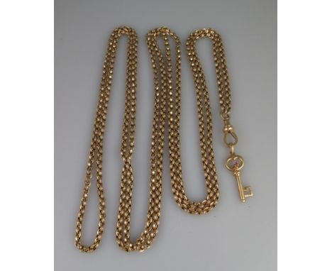 A VICTORIAN 9CT GOLD GUARD CHAIN with yellow metal ruby set key pendant. Length of chain 62" (154cm) approx. Weight in total 