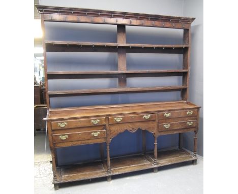 EARLY 19TH CENTURY WELSH SWANSEA VALLEY POT BOARD DRESSER having moulded cornice over three shelf reeded open rack, the base 