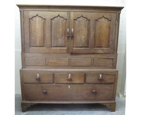 EARLY 19TH CENTURY WELSH OAK LINEN PRESS CUPBOARD having moulded cornice above four fielded ogee panels with ivory escutcheon